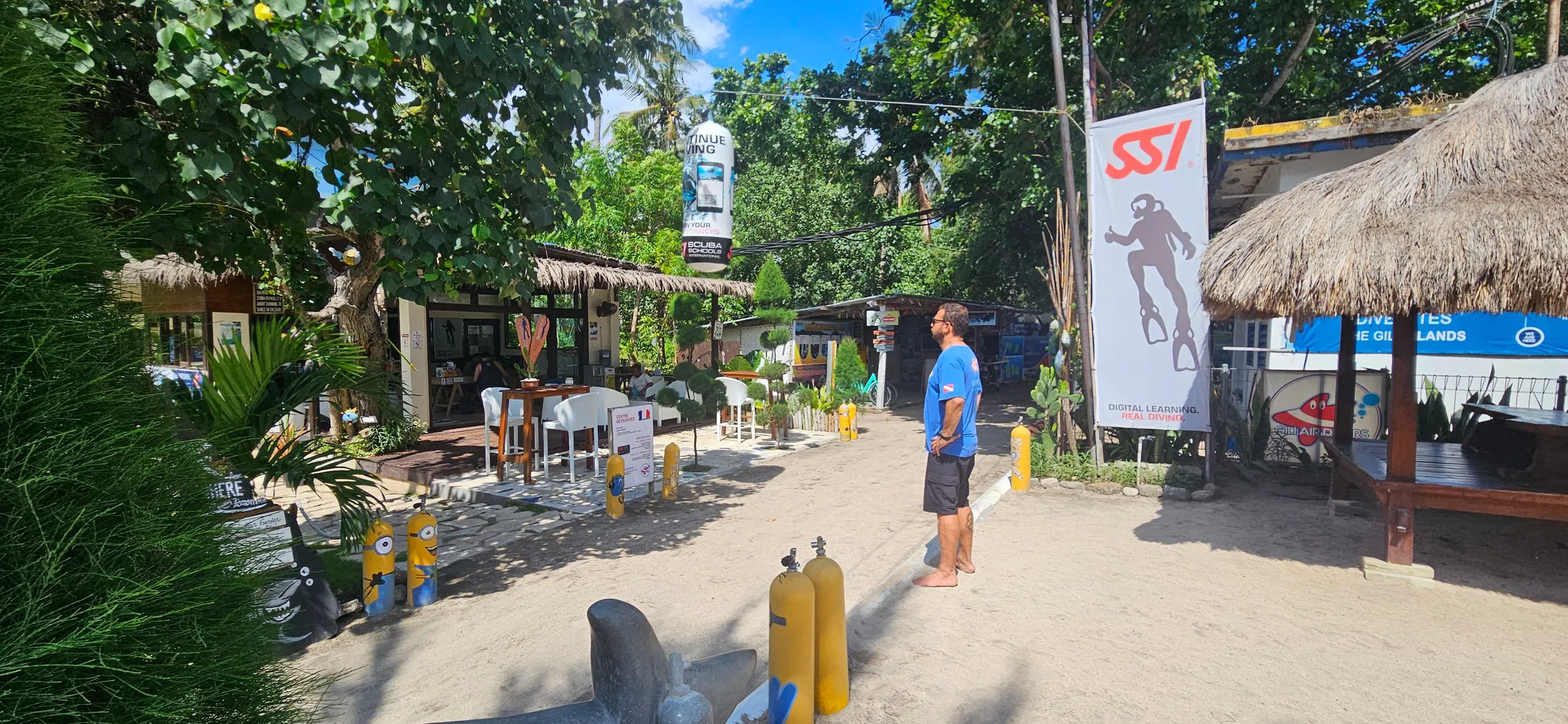 Beach path with stacked tanks