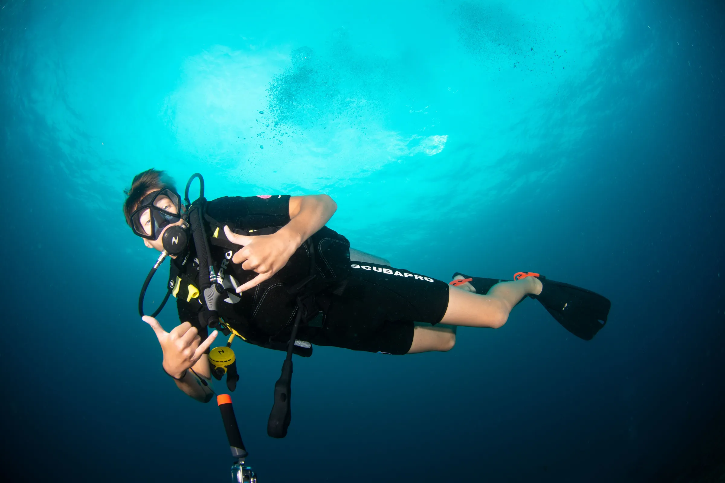 Diver posing in dark blue water