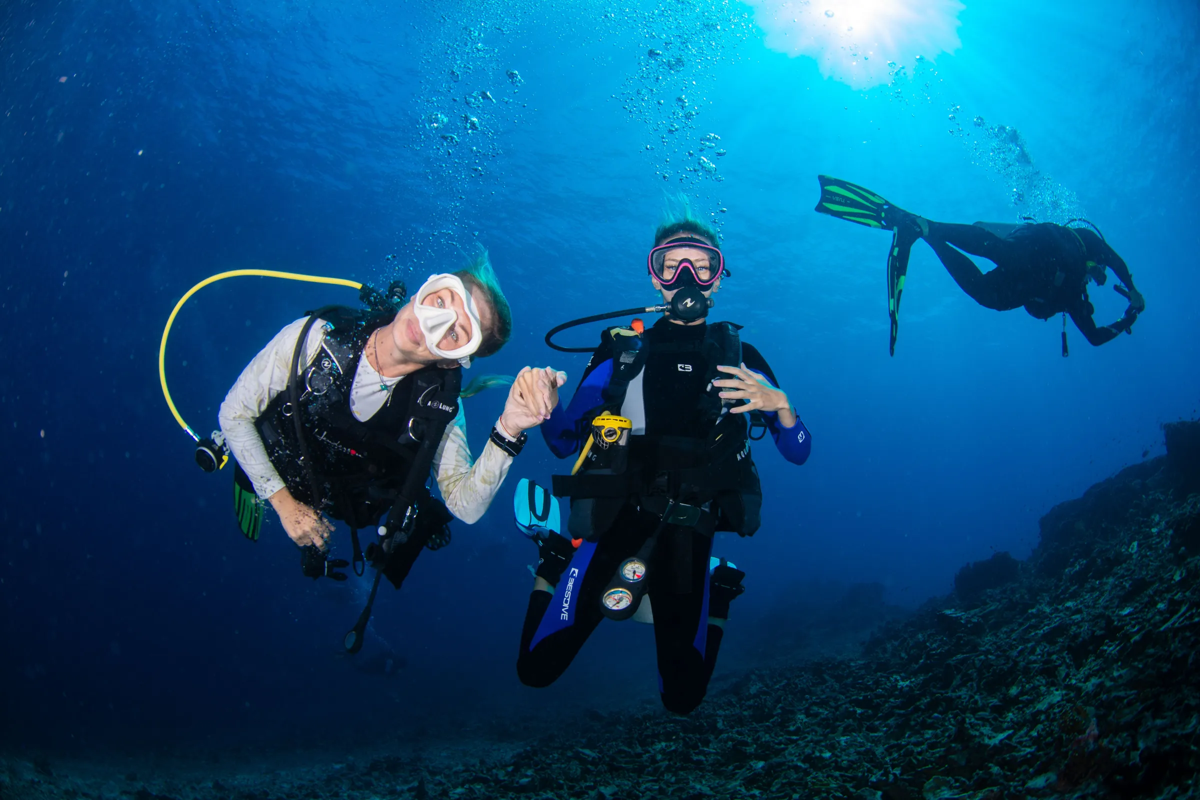Two divers posing in the blue