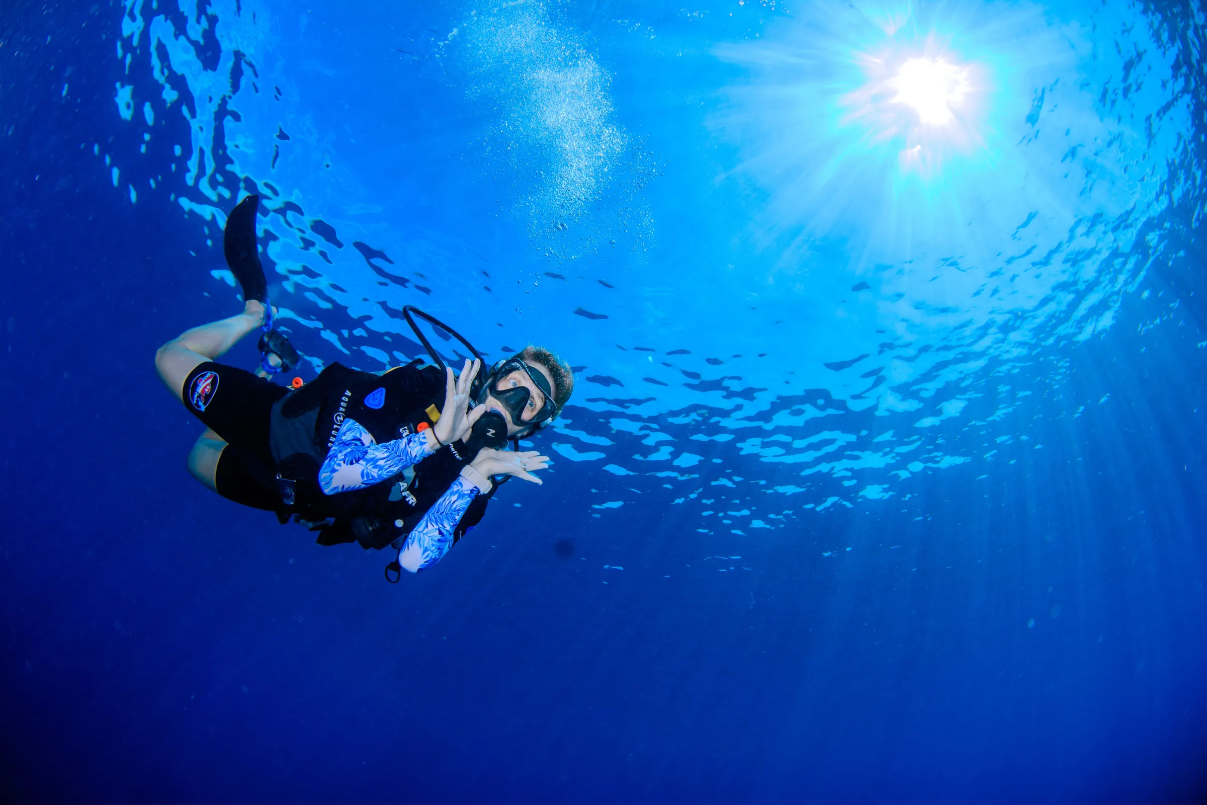 Diver gliding through deep blue