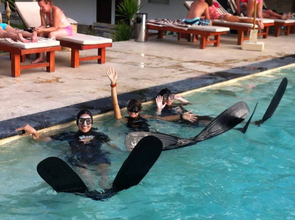 Free Diver in fins lounging poolside